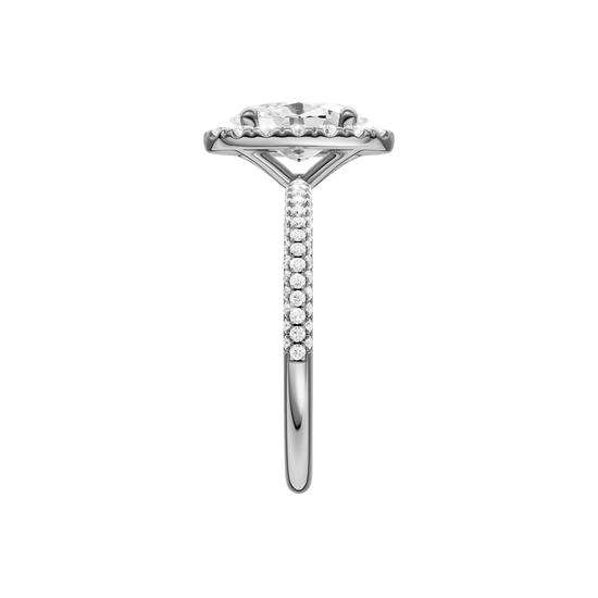 A side view of the oval cut diamond engagement ring in 14k white gold with a pavé diamond band and solitaire setting