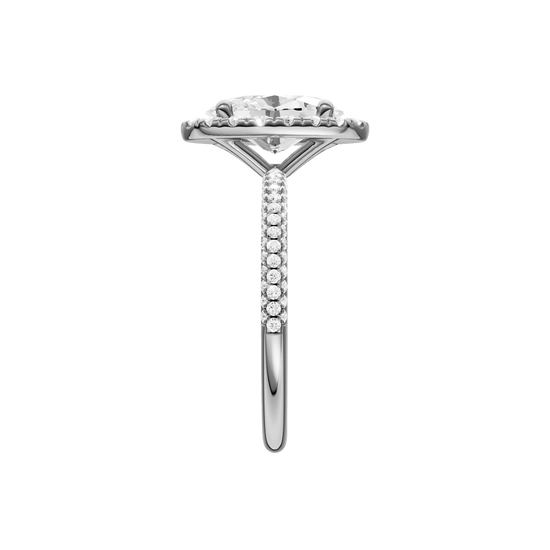 A side view of the oval cut diamond engagement ring in platinum with a pavé diamond band and solitaire setting