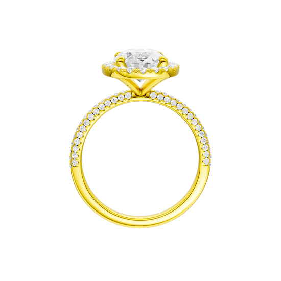 A profile  view of the oval cut diamond engagement ring in 14k yellow gold with a pavé diamond band and solitaire setting