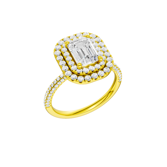A three-quarter view of the Emerald cut diamond engagement ring in 14k yellow gold with a pavé diamond band and solitaire setting