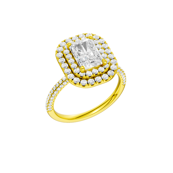 A three-quarter view of the Radiant cut diamond engagement ring in 14k yellow gold with a pavé diamond band and solitaire setting