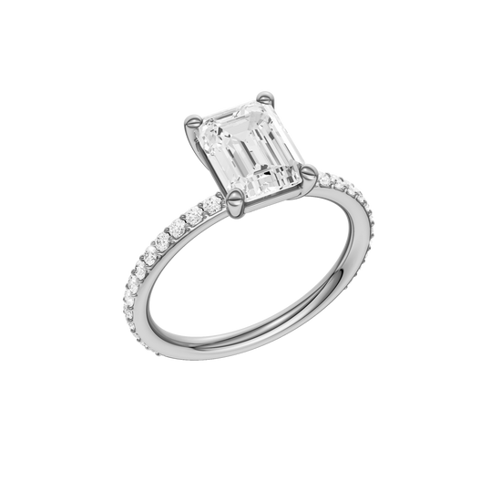 A three-quarter view of the Emerald cut diamond engagement ring in 14k white gold with a prong diamond band and cathedral setting