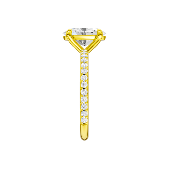 A side view of the Oval cut diamond engagement ring in 14k yellow gold with a prong diamond band and cathedral setting