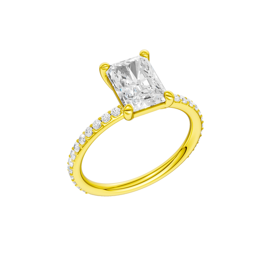 A three-quarter view of the radiant cut diamond engagement ring in 14k yellow gold with a prong diamond band and cathedral setting