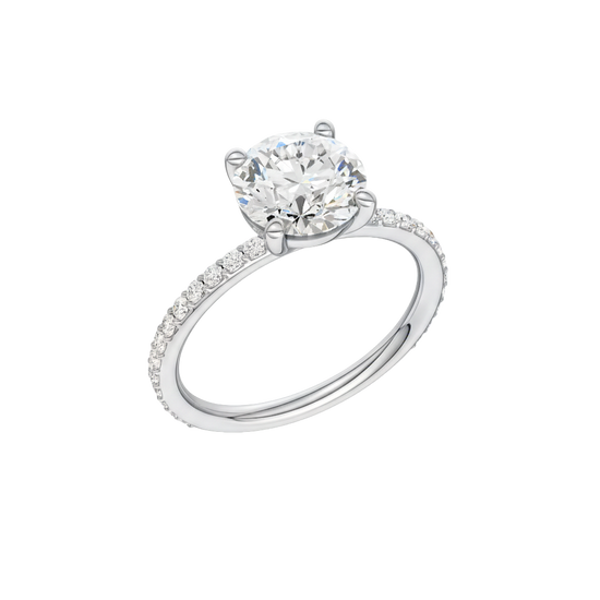 A three-quarter view of the Round cut diamond engagement ring in 14k white gold with a prong diamond band and cathedral setting