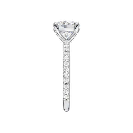 A side view of the Round cut diamond engagement ring in platinum with a prong diamond band and cathedral setting
