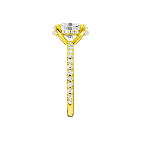A side view of the Oval cut diamond engagement ring in 14k yellow gold with a prong diamond band and cathedral setting