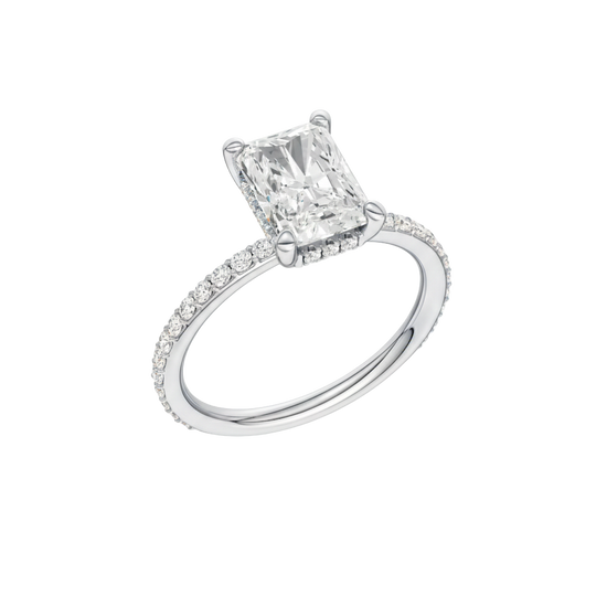 A three-quarter view of the Radiant cut diamond engagement ring in 14k white gold with a diamond band and hidden halo, cathedral setting