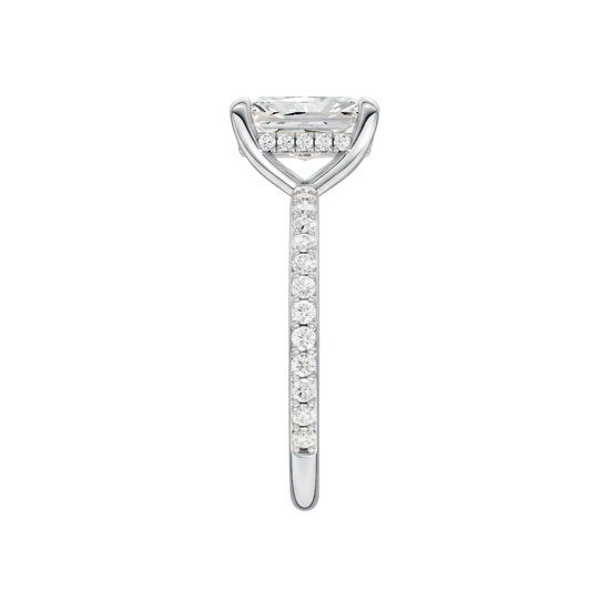 A side view of the Radiant cut diamond engagement ring in 14k white gold with a diamond band and hidden halo, cathedral setting