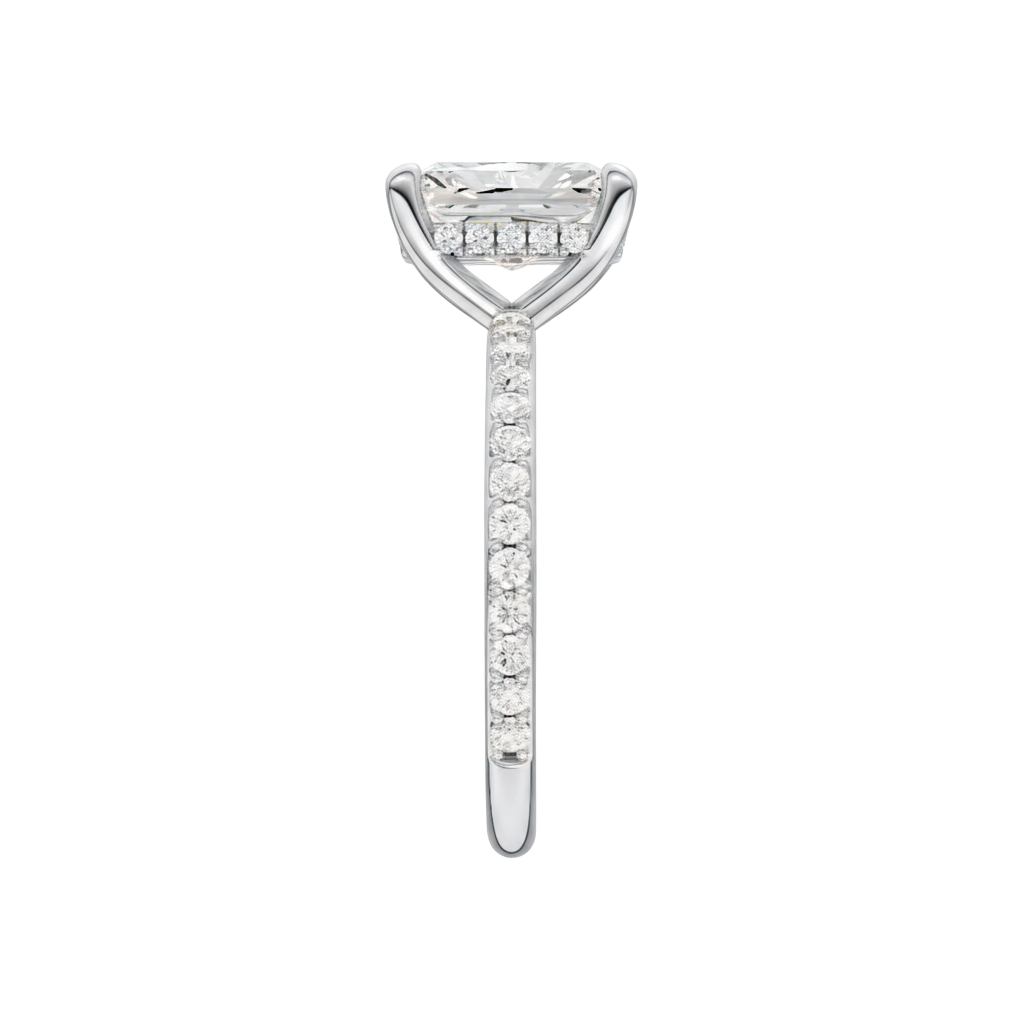 A side view of the Radiant cut diamond engagement ring in platinum with a diamond band and hidden halo, cathedral setting