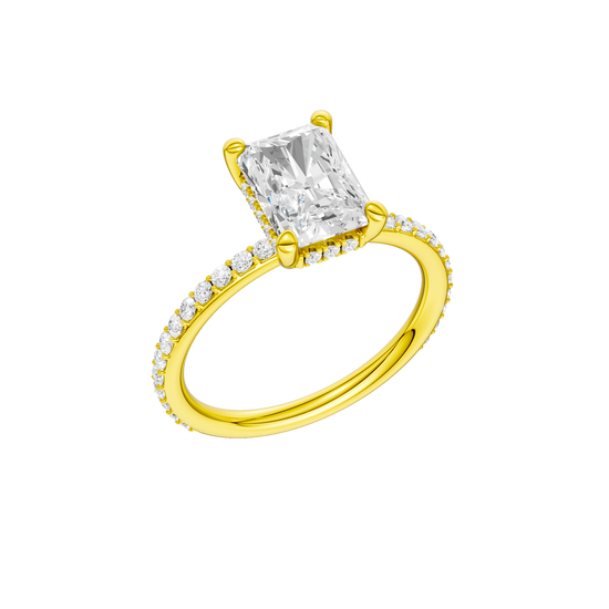A three-quarter view of the Radiant cut diamond engagement ring in 14k yellow gold with a diamond band and hidden halo, cathedral setting