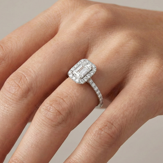Emerald cut diamond engagement ring in 14k white gold with a prong diamond band and cathedral setting on a hand