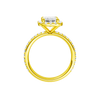 A profile view of the Emerald cut diamond engagement ring in 14k yellow gold with a prong diamond band and cathedral setting