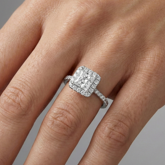 Princess cut diamond engagement ring in 14k white gold with a prong diamond band and cathedral setting on a hand