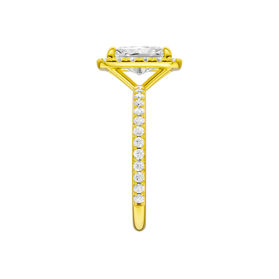 A side view of the radiant cut diamond engagement ring in 14k yellow gold with a prong diamond band and cathedral setting