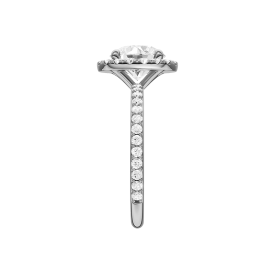 A side view of the Round cut diamond engagement ring in platinum with a prong diamond band and cathedral setting