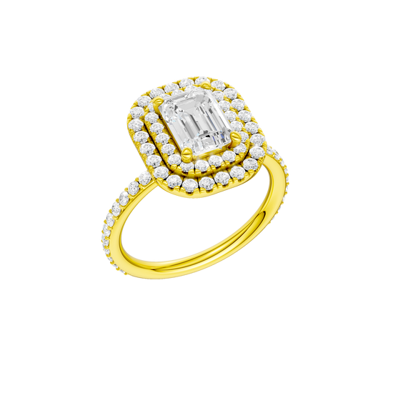 A three-quarter view of the Emerald cut diamond engagement ring in 14k yellow gold with a prong diamond band and cathedral setting