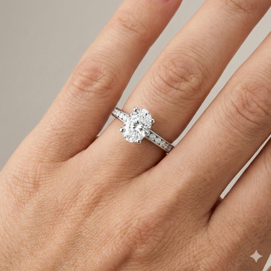 Oval cut diamond engagement ring in 14k white gold with a diamond channel band and cathedral setting on a hand