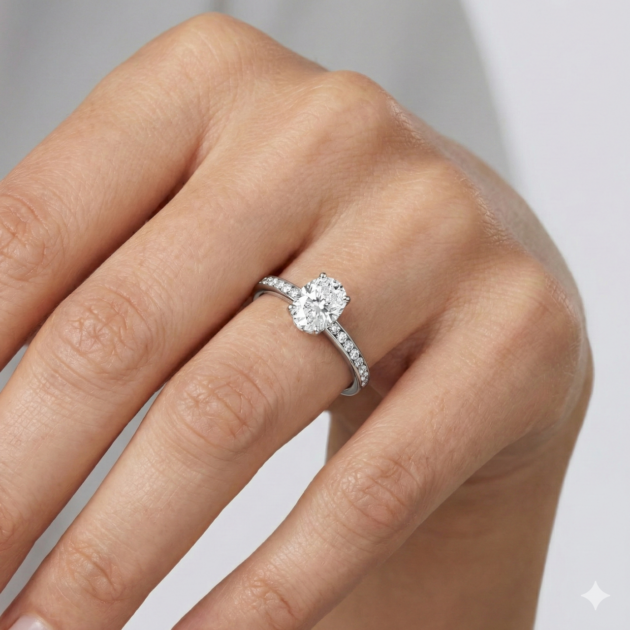 Elongated cushion cut diamond engagement ring in 14k white gold with a diamond channel band and cathedral setting on a hand