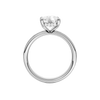 A profile view of the Elongated Cushion cut diamond engagement ring in platinum with a channel band and hidden halo setting