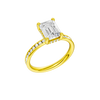 A three-quarter view of the Emerald cut diamond engagement ring in 14k yellow gold with a diamond channel band and cathedral setting