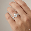 Pear cut diamond engagement ring in 14k white gold with a diamond channel band and cathedral setting on a hand