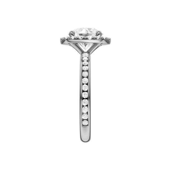 A side view of the Round cut diamond engagement ring in 14k white gold with a diamond channel band and halo setting