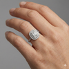 Emerald cut diamond engagement ring in 14k white gold  with a channel band and double halo setting on a hand