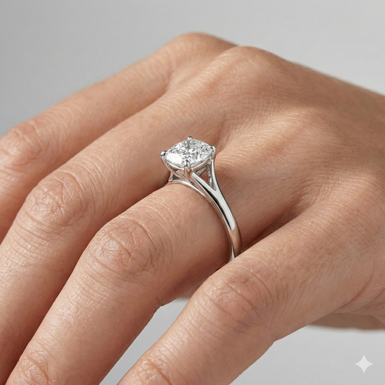 Elongated cushion cut diamond engagement ring in 14k white gold with a plain band and split setting on a hand