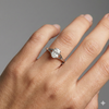 Oval cut diamond engagement ring in 14k white gold with a plain band and split setting on a hand