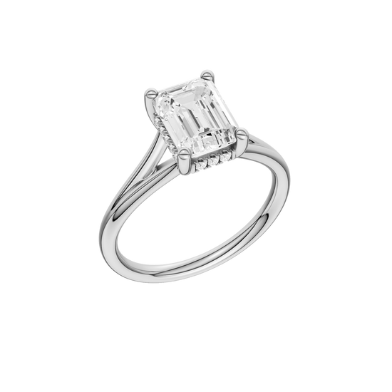 A three-quarter view of the Emerald cut diamond engagement ring in platinum with a plain band and hidden halo setting