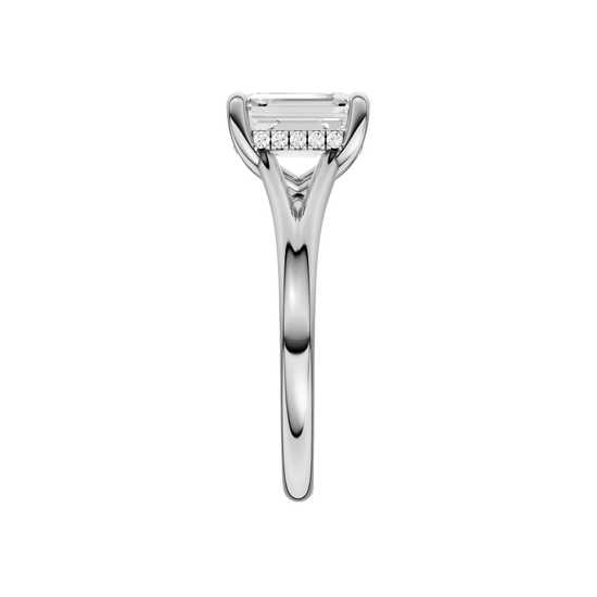 A side view of the Emerald cut diamond engagement ring in platinum with a plain band and hidden halo setting
