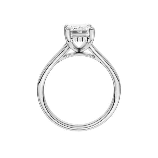 A profile view of the Emerald cut diamond engagement ring in platinum with a plain band and hidden halo setting