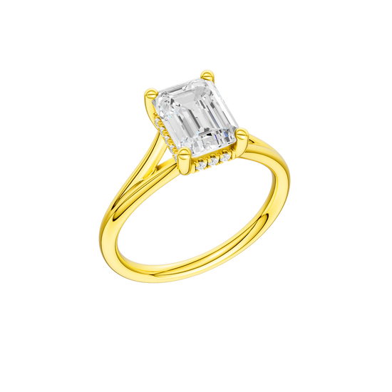 A three-quarter view of the Emerald cut diamond engagement ring in 14k yellow gold with a plain band and hidden halo setting