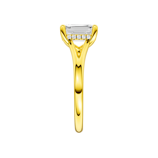 A side view of the Emerald cut diamond engagement ring in 14k yellow gold with a plain band and hidden halo setting
