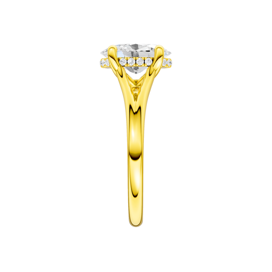 A side view of the Oval cut diamond engagement ring in 14k yellow gold with a plain band and hidden halo setting