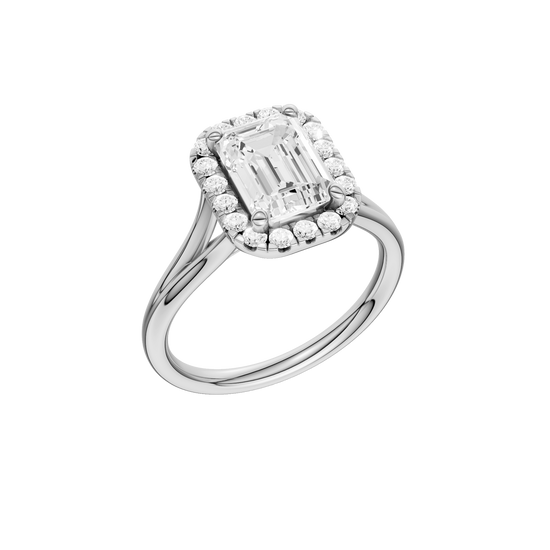 A three-quarter view of the Emerald cut diamond engagement ring in 14k white gold with a plain band and halo setting
