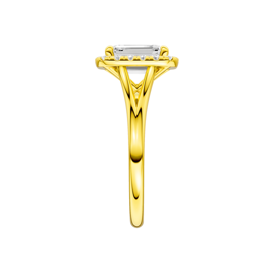A side view of the Emerald cut diamond engagement ring in 14k yellow gold with a plain band and halo setting