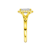 A side view of the Emerald cut diamond engagement ring in 14k yellow gold with a plain band and halo setting
