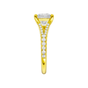 A side view of the Emerald cut diamond engagement ring in 14k yellow gold with a prong band and solitaire setting