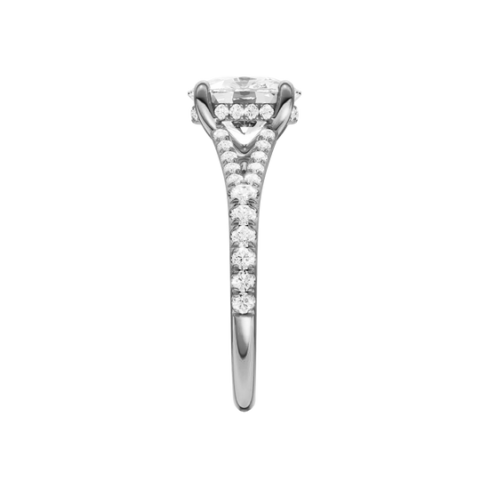 A side view of the Elongated Cushion cut diamond engagement ring in platinum with a diamond band and hidden halo setting