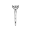 A side view of the Elongated Cushion cut diamond engagement ring in platinum with a diamond band and hidden halo setting