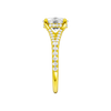 A side view of the Elongated Cushion cut diamond engagement ring in 14k yellow gold with a diamond band and hidden halo setting