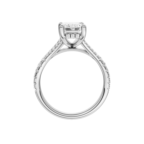A profile view of the Emerald cut diamond engagement ring in 14k white gold with a prong diamond band and hidden halo setting