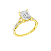 A three-quarter view of the Emerald cut diamond engagement ring in 14k yellow gold with a prong diamond band and hidden halo setting