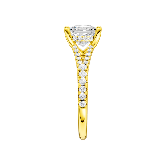 A side view of the Princess cut diamond engagement ring in 14k yellow gold with a prong band and hidden halo setting