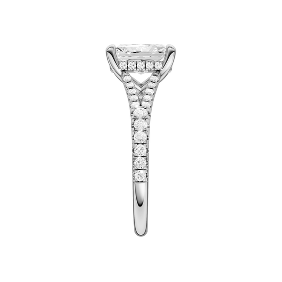 A side view of the Radiant cut diamond engagement ring in platinum with a prong band and hidden halo setting