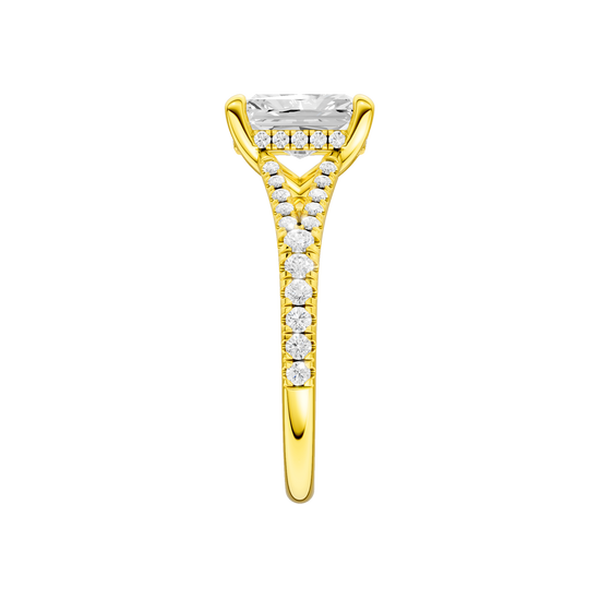 A side view of the Radiant cut diamond engagement ring in 14k yellow gold with a prong band and hidden halo setting