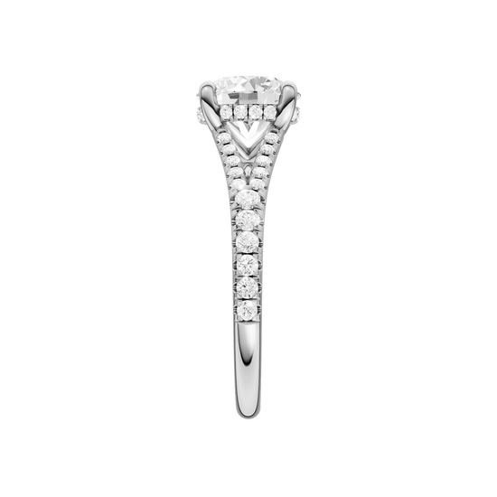 A side view of the Round cut diamond engagement ring in platinum with a prong band and hidden halo setting