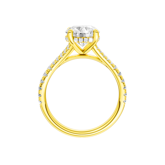 A profile view of the Round cut diamond engagement ring in 14k yellow gold with a prong band and hidden halo setting